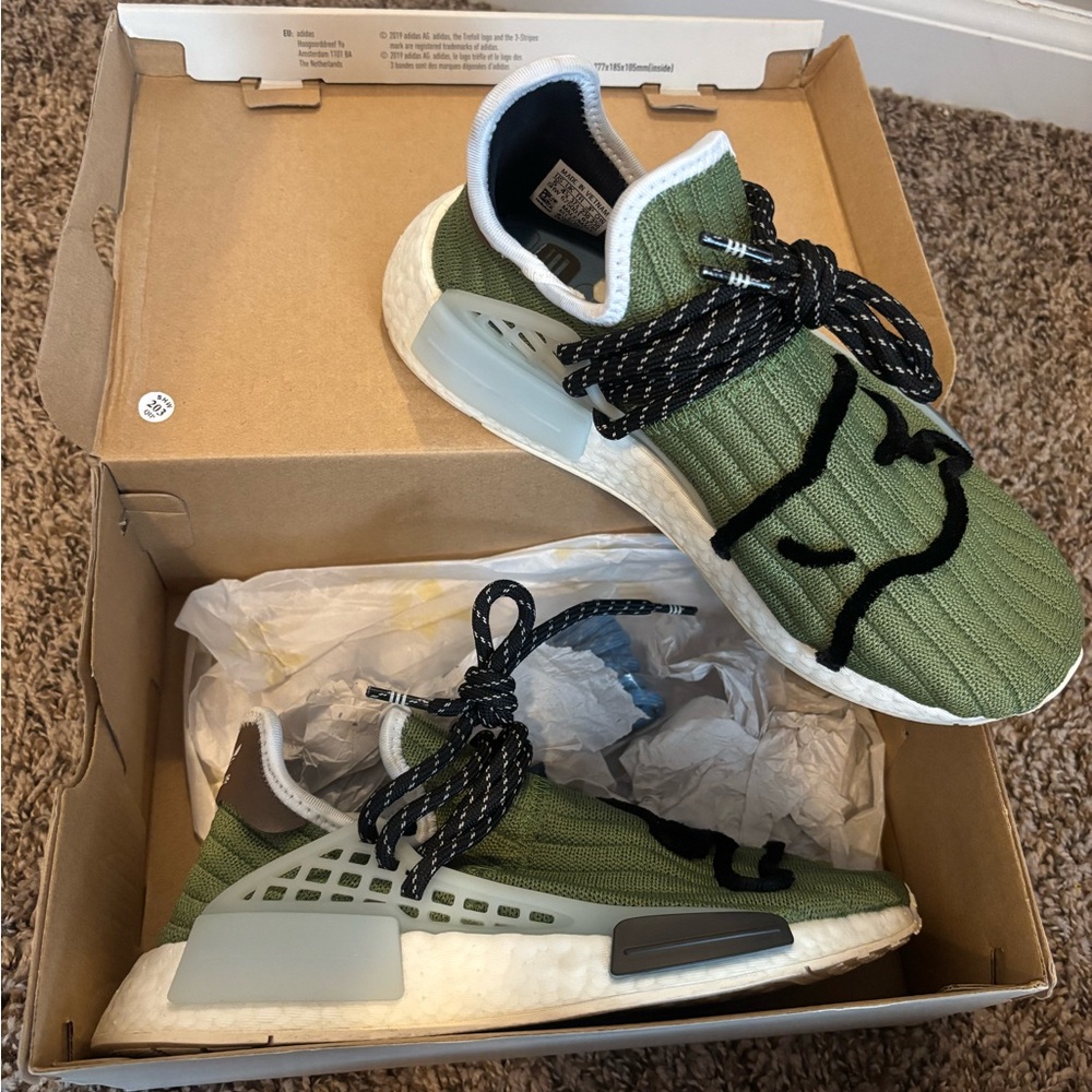 Adidas x Pharrell Williams Hu NMD “Olive Green” sneakers.